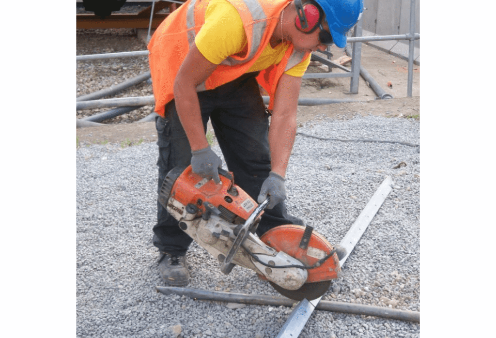 A workman using their abrasive wheels in a safe way after finishing their abrasive wheels training.